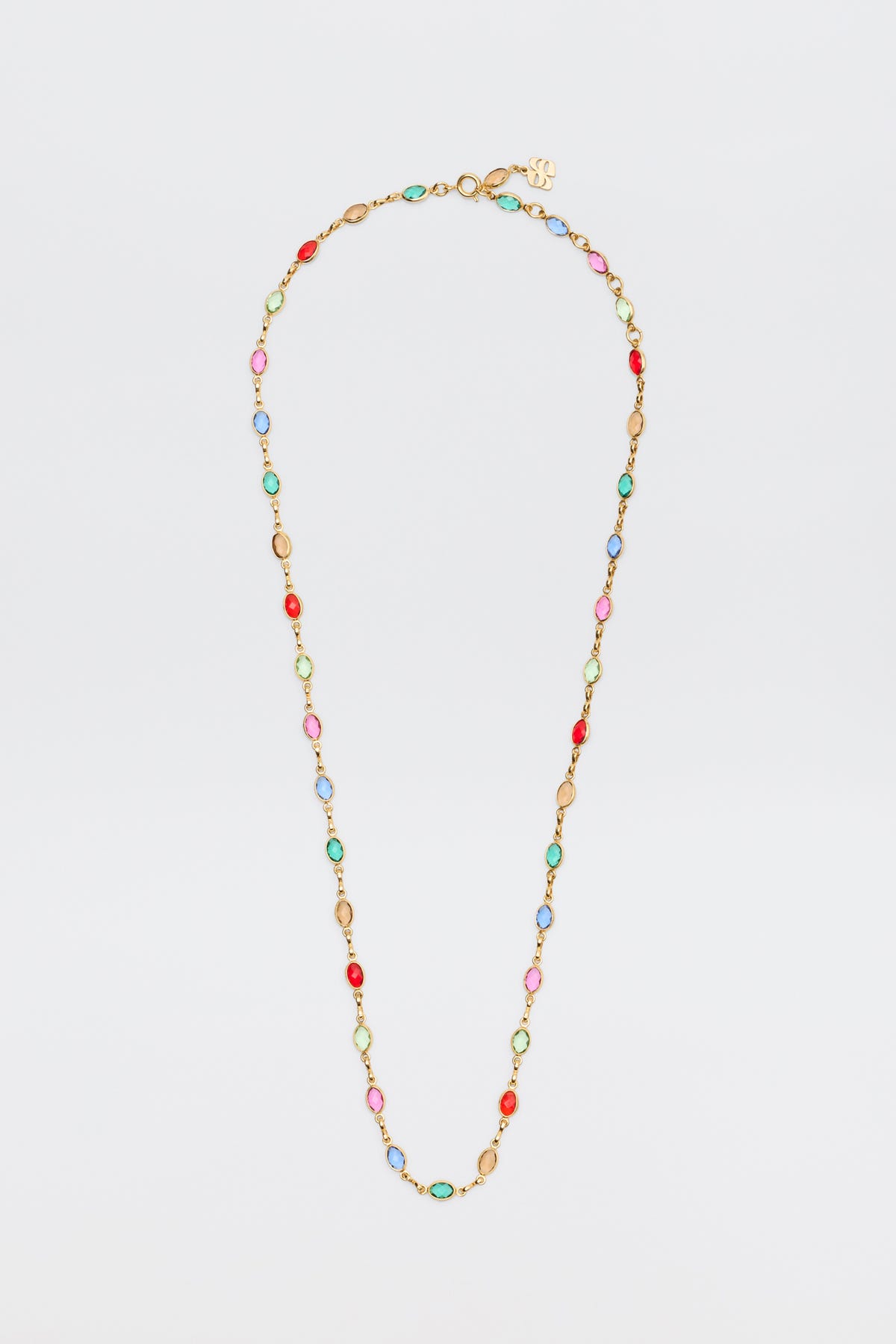 The Annabeth - Multi is a gold chain necklace featuring alternating oval beads in red, pink, blue, and green, showcased against a plain white background.