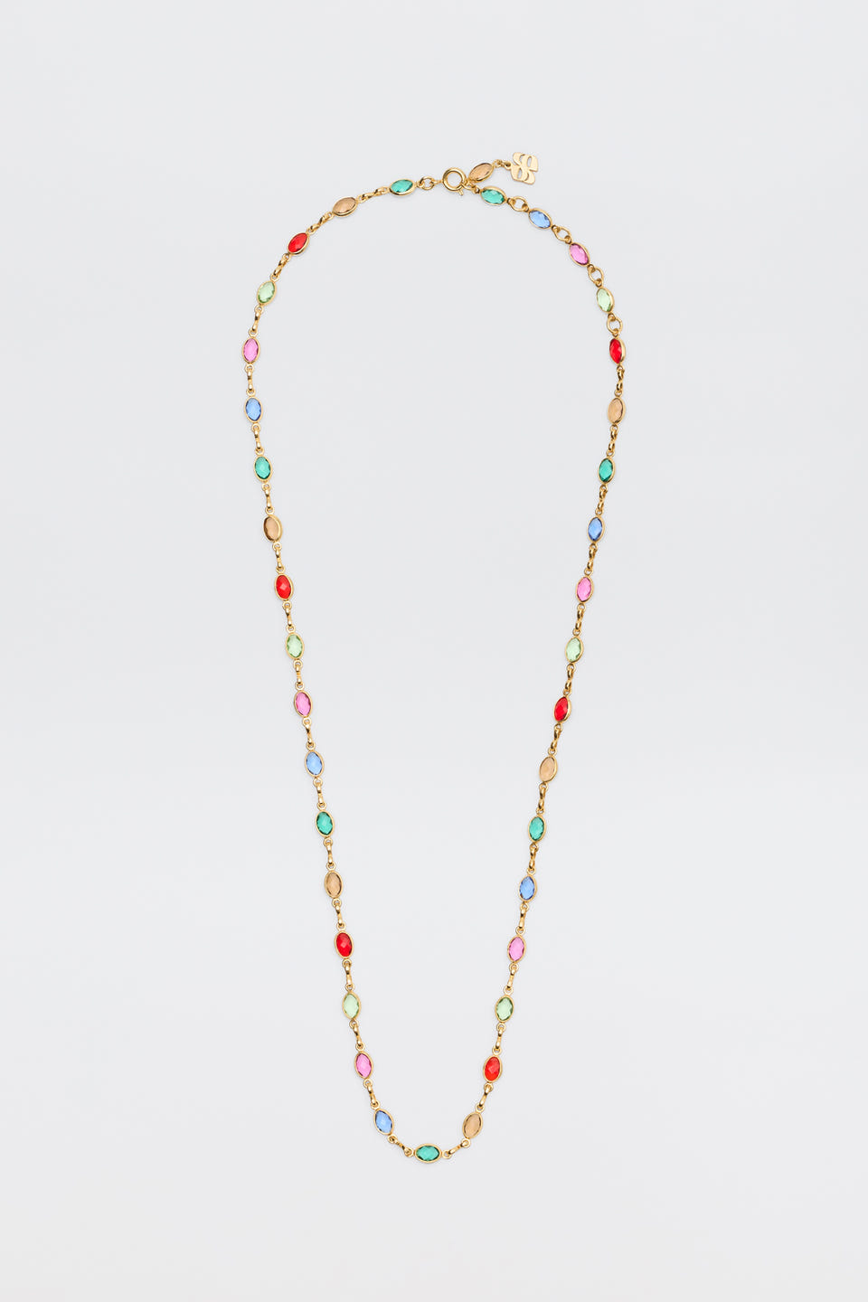 The Annabeth - Multi is a gold chain necklace featuring alternating oval beads in red, pink, blue, and green, showcased against a plain white background.