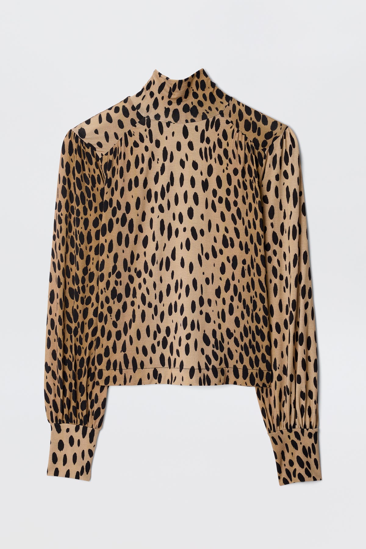 The Suki - Antelope Spot Black is a long-sleeve, high-neck top featuring a tan base with bold black and brown antelope print spots, shown flat on a white background.
