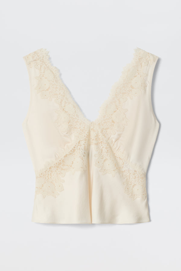 Emmie - Pearl: Cream-colored, sleeveless satin camisole featuring a deep V neckline and delicate lace trim on the front and shoulders, styled as an elegant separate and laid flat on a white background.