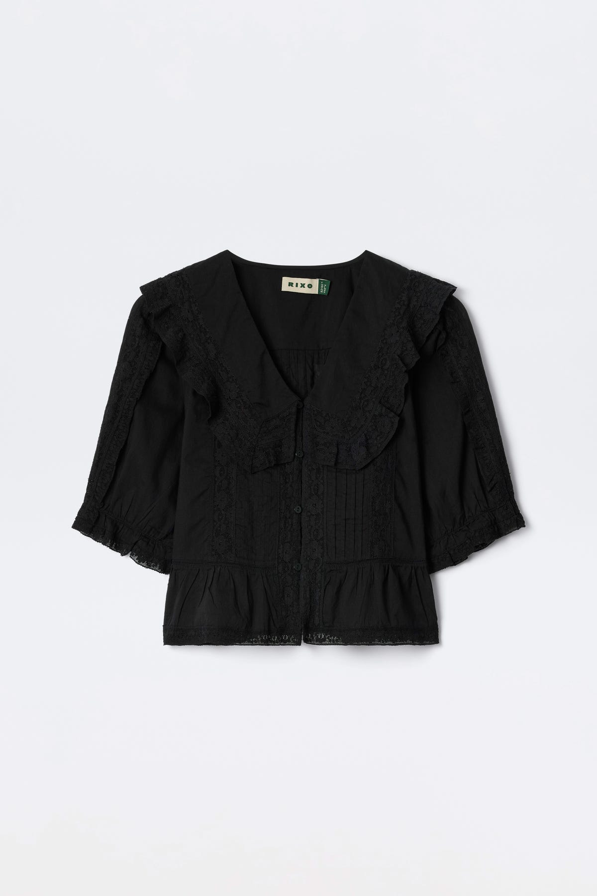 Ellery - Black: A vintage-inspired black cotton button-down top with a large lace-trimmed collar, 3/4 lace-detailed sleeves, and a ruffled hem, shown flat on a white background.