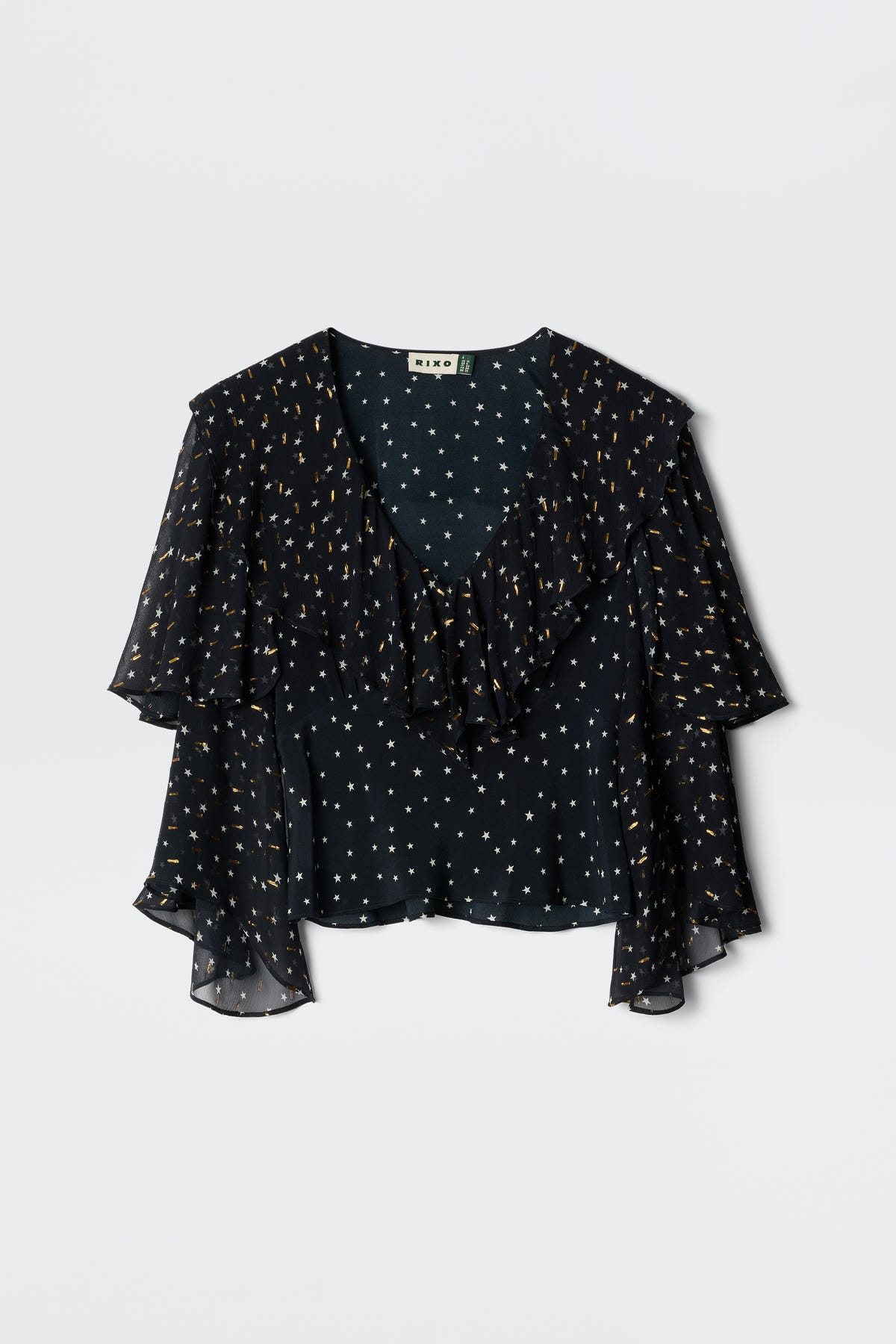 Ramira - Starry Night Navy blouse featuring a sheer black fabric adorned with white stars and gold dots, designed with a ruffled V-neckline and flowy short sleeves, displayed on a plain light background.