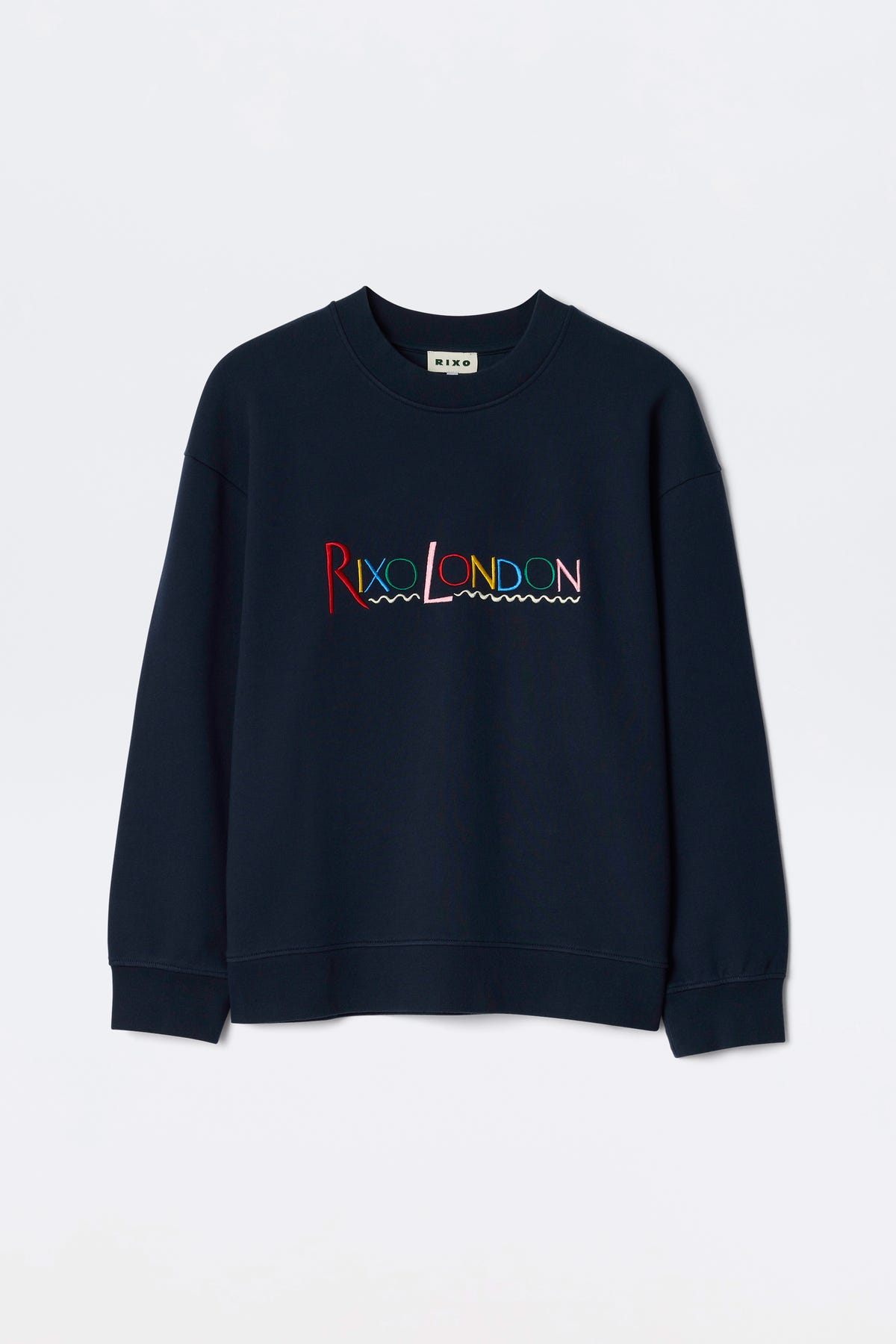 The Blaze - London Embroidery Navy is a navy blue crewneck sweatshirt featuring RIXO LONDON in colorful, wave-underlined embroidery across the chest.