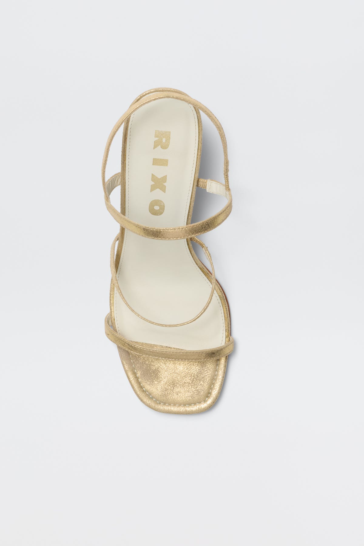 The Ciervo - Gold is a comfortable strappy sandal with a square toe and cream insole, featuring RIXO in gold on the footbed—the perfect match for elevating your RIXO occasion wear, shown against a white background.