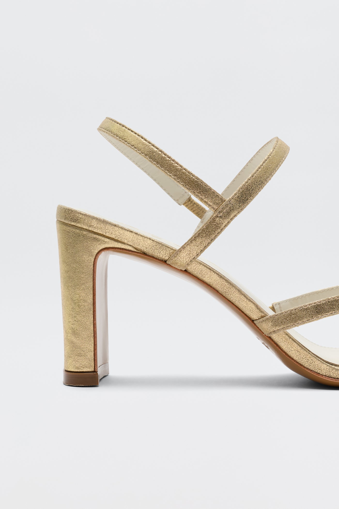 Ciervo - Gold: a gold block-heeled sandal featuring thin toe and ankle straps with a minimalist design—ideal for RIXO occasion wear, shown on a plain white background.