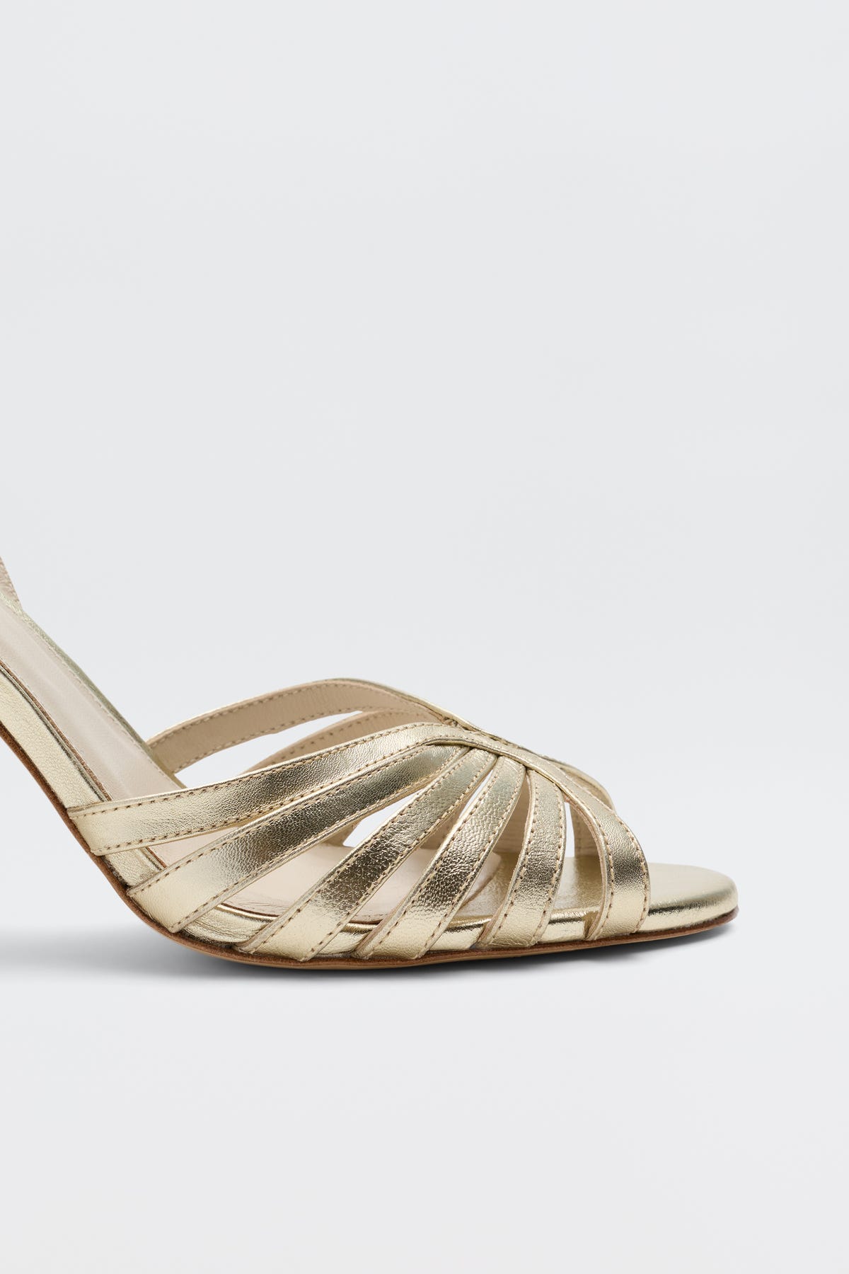 The Mavi - Gold sandals feature gold strappy high heels, open toes, and crisscrossing leather straps—a stunning women's footwear choice shown from a side angle against a plain white background.