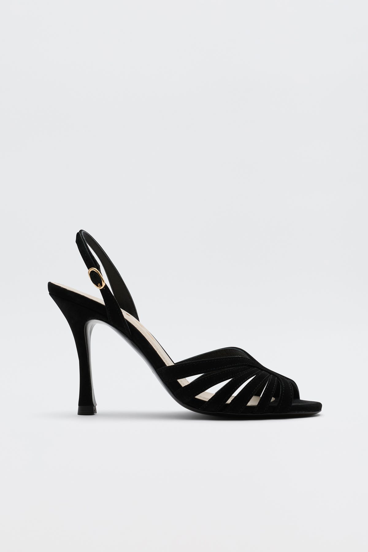 The Mavi - Black high-heeled sandal features an open toe, slim straps, a slingback with gold buckle, and a sleek heel—ideal for adding glamour to any look. Shown against a simple light backdrop.