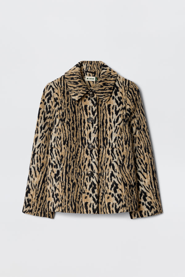 The Tommie - Bohemia Leopard jacket, made from faux fur with a bold brown and black leopard print, features a collar, long sleeves, and large front buttons. It is shown against a plain white background.