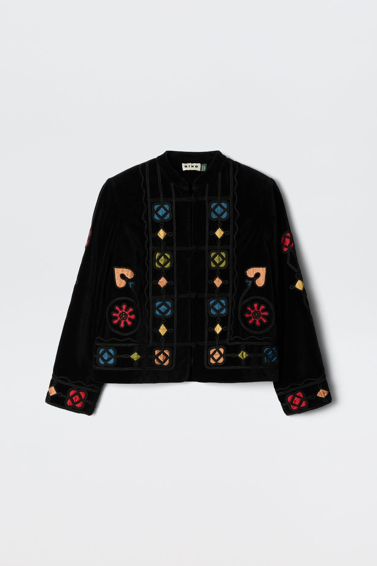 The Viktoria - Serino Applique Black jacket features black velvet and colorful embroidered geometric and floral patterns in red, blue, yellow, and beige, displayed on a plain white background.
