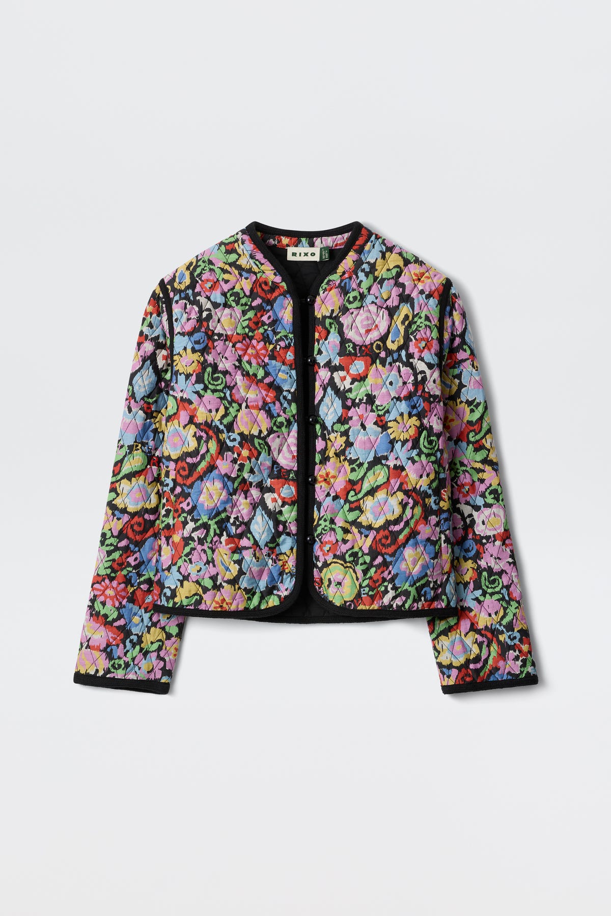 The Lyanne - Ikat Bloom Charcoal is a colorful, long-sleeve, quilted jacket featuring a floral patchwork pattern, black trim along the edges, and an open front, displayed against a plain white background.