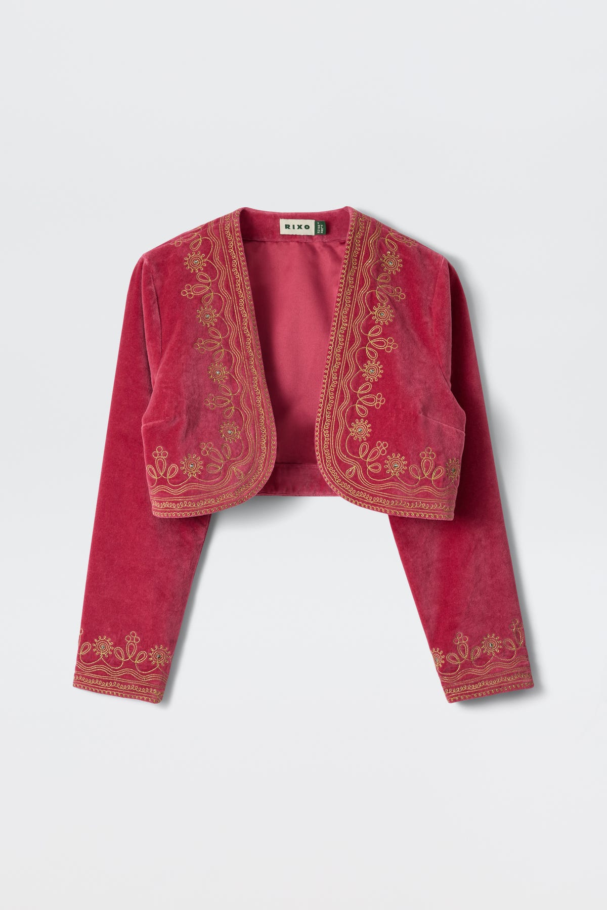 The Cliona - Soutache Embroidery Magenta Pink is a cropped, long-sleeve velvet jacket featuring gold floral embroidery along the edges, cuffs, and front panels, shown against a plain light background.