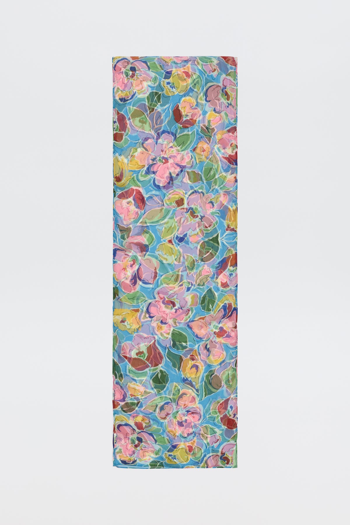 The Julien - Jeannie Bloom Sky is a rectangular yoga mat showcasing a vibrant floral pattern with pink, yellow, and blue flowers plus green leaves on a light, multicolored background.