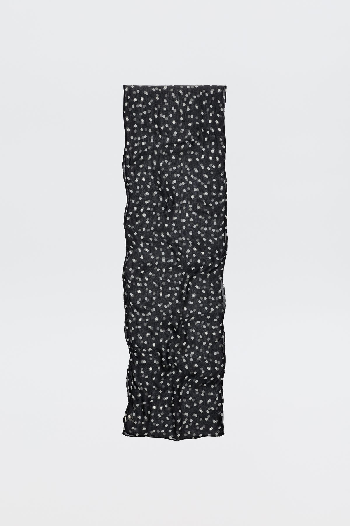 The Julien - Emma Spot Deep Navy scarf is long and black with a soft, quilted texture and small white floral spots, shown against a plain white background.