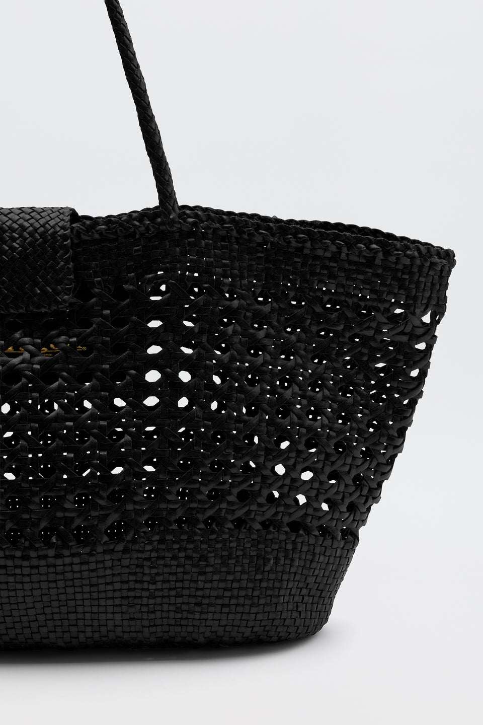 Black woven handbag on a light gray background
