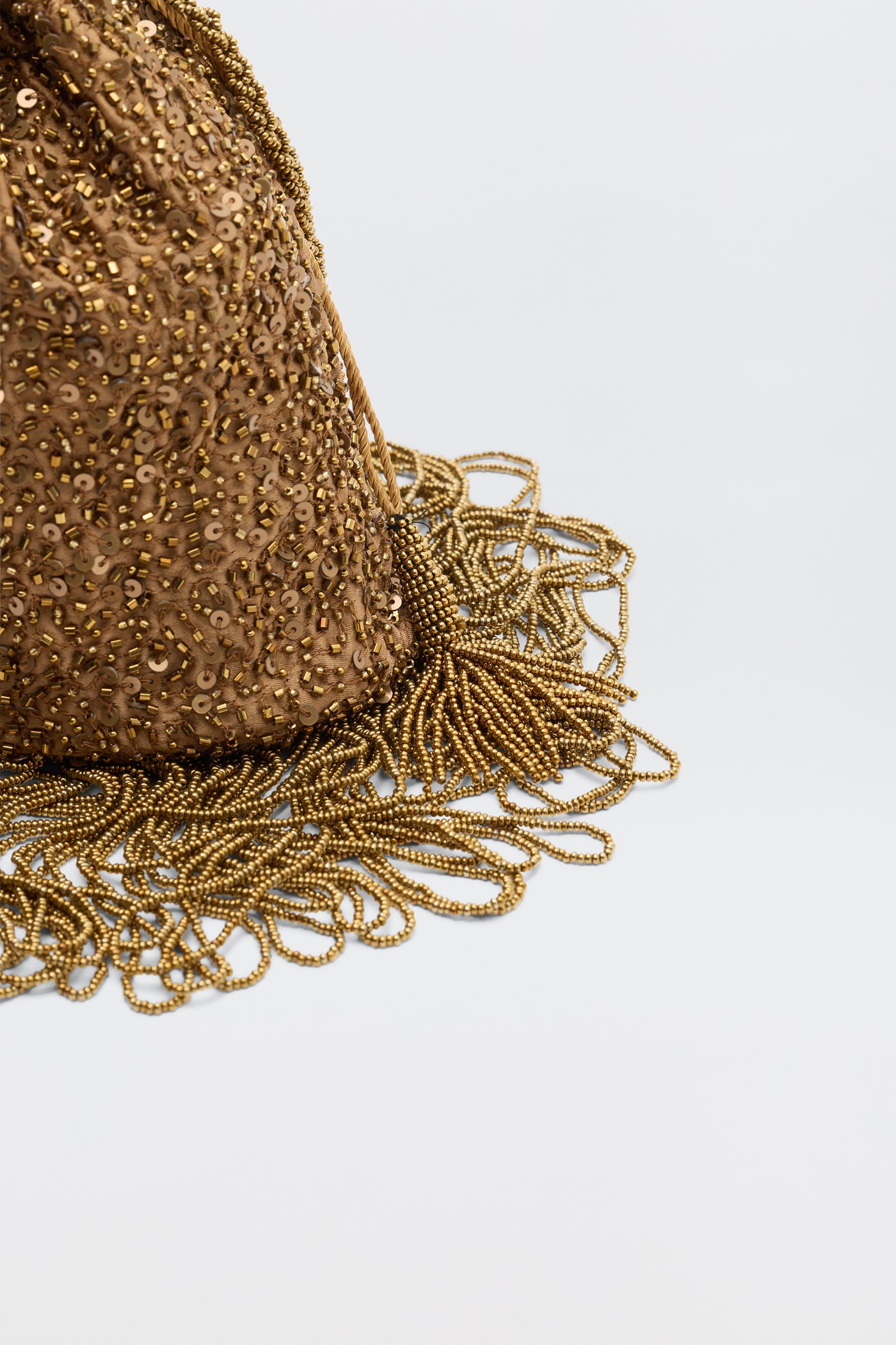 A close-up of the Orla - Vintage Scatter Embellishment Gold bag, featuring gold sequins and beaded fringe, displayed against a plain light background.