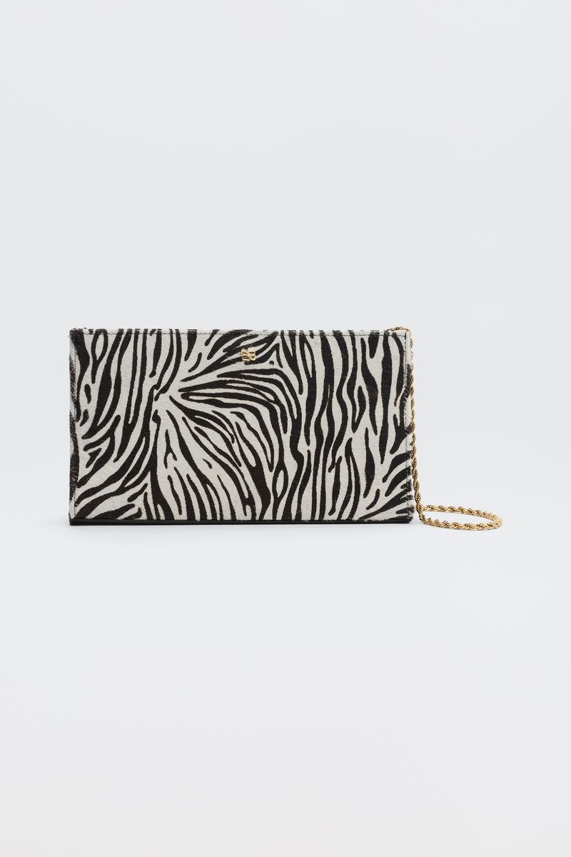 Kamila - Zebra Print Brown rectangular clutch bag with a brown and cream zebra print and a gold-tone chain strap.