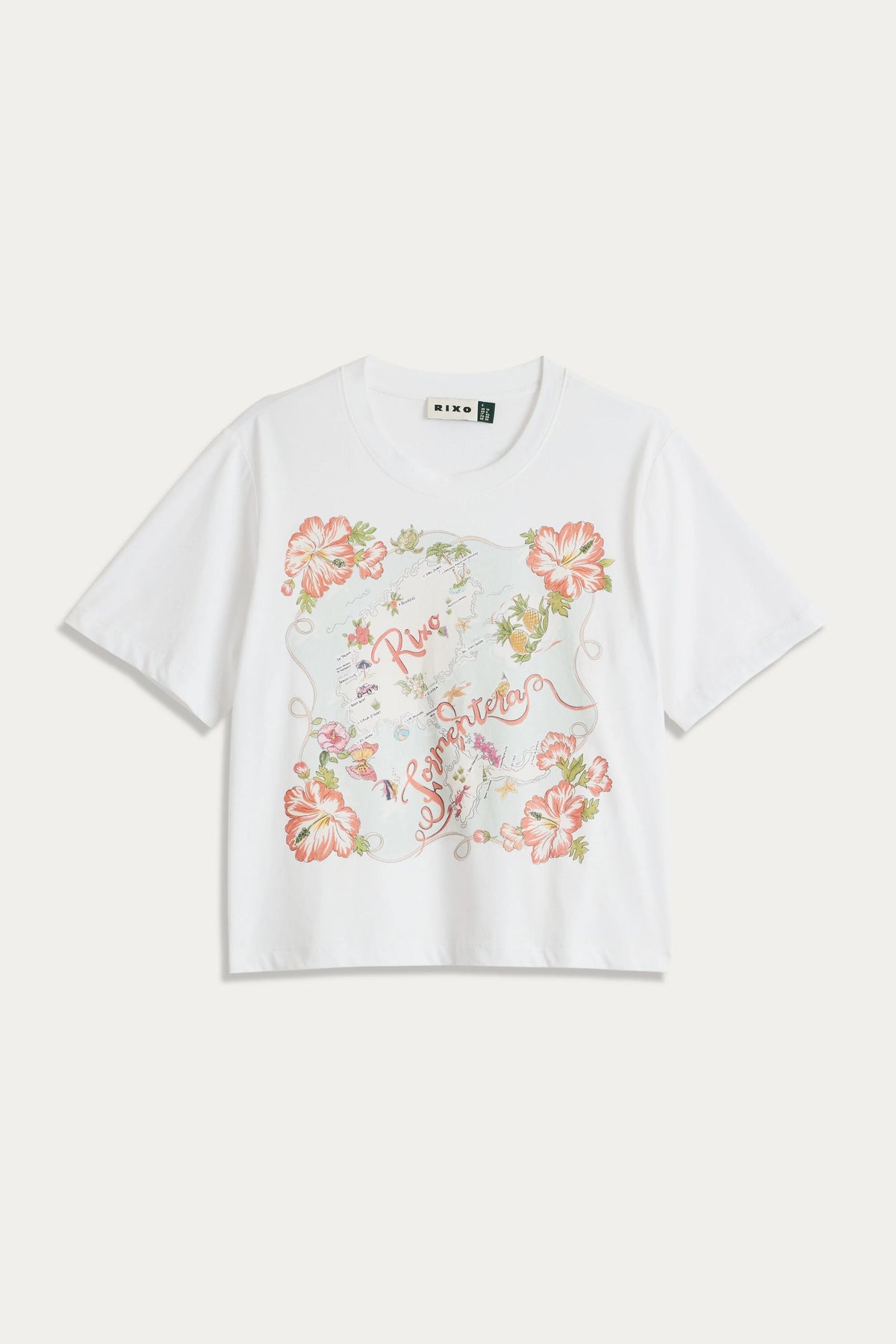 The Sabria - Ibiza Souvenir White short-sleeve T-shirt features a colorful floral design with red, pink, and green flowers, script text at the center, vintage poster-inspired accents, and decorative elements.