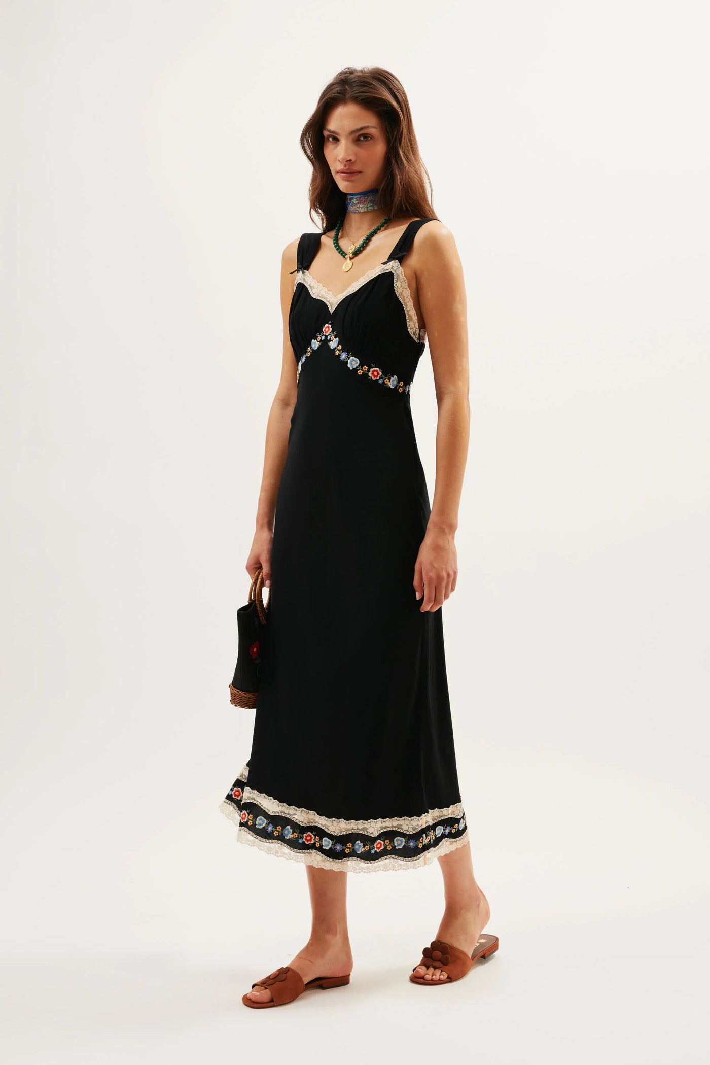 A woman in the Lucie - Bloom Embroidery Black vintage crepe de chine dress.