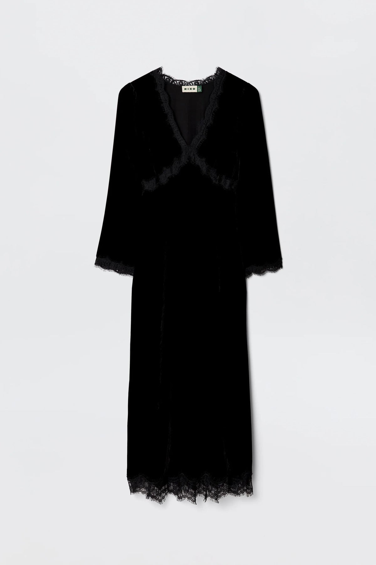 The Alessi - Black is a long-sleeved black velvet dress with boho-glam lace detailing on the neckline, sleeves, and hem, shown against a plain light background.