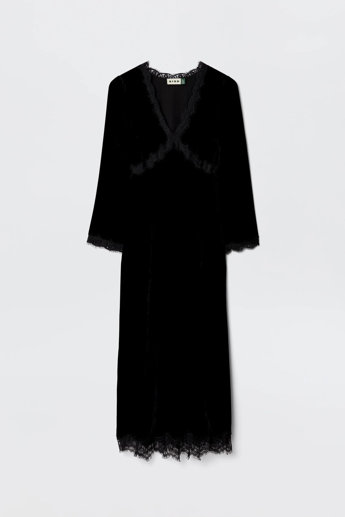 The Alessi - Black is a long-sleeved black velvet dress with boho-glam lace detailing on the neckline, sleeves, and hem, shown against a plain light background.