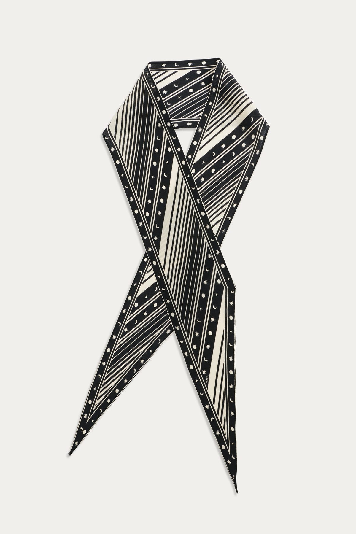 The Yelina - Starstruck Black silk scarf is displayed in a crisscross layout, highlighting its bold black and white diagonal stripes and small polka dots against a white background.