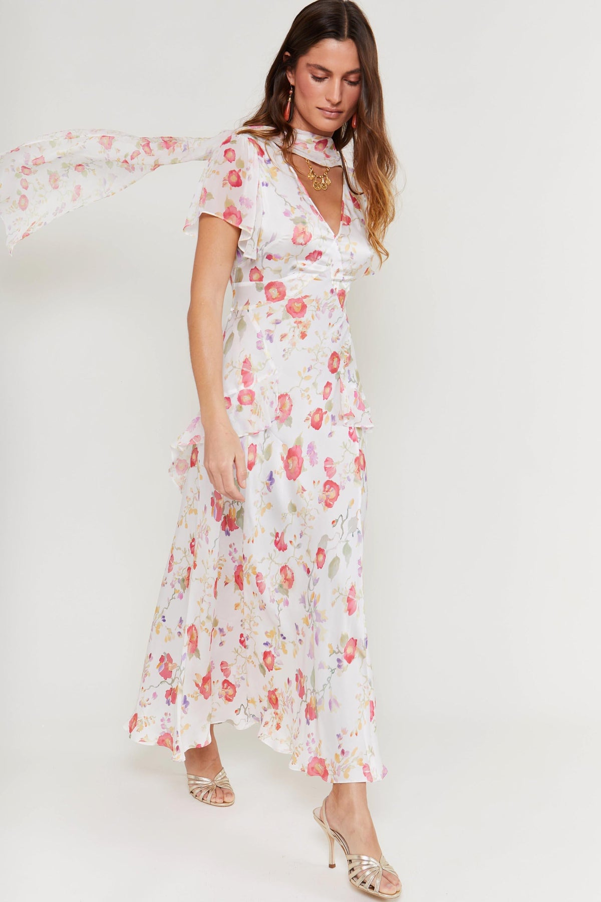 A woman in a white dress channels occasion style, echoing the elegance of the evie - waterblossom ivory.