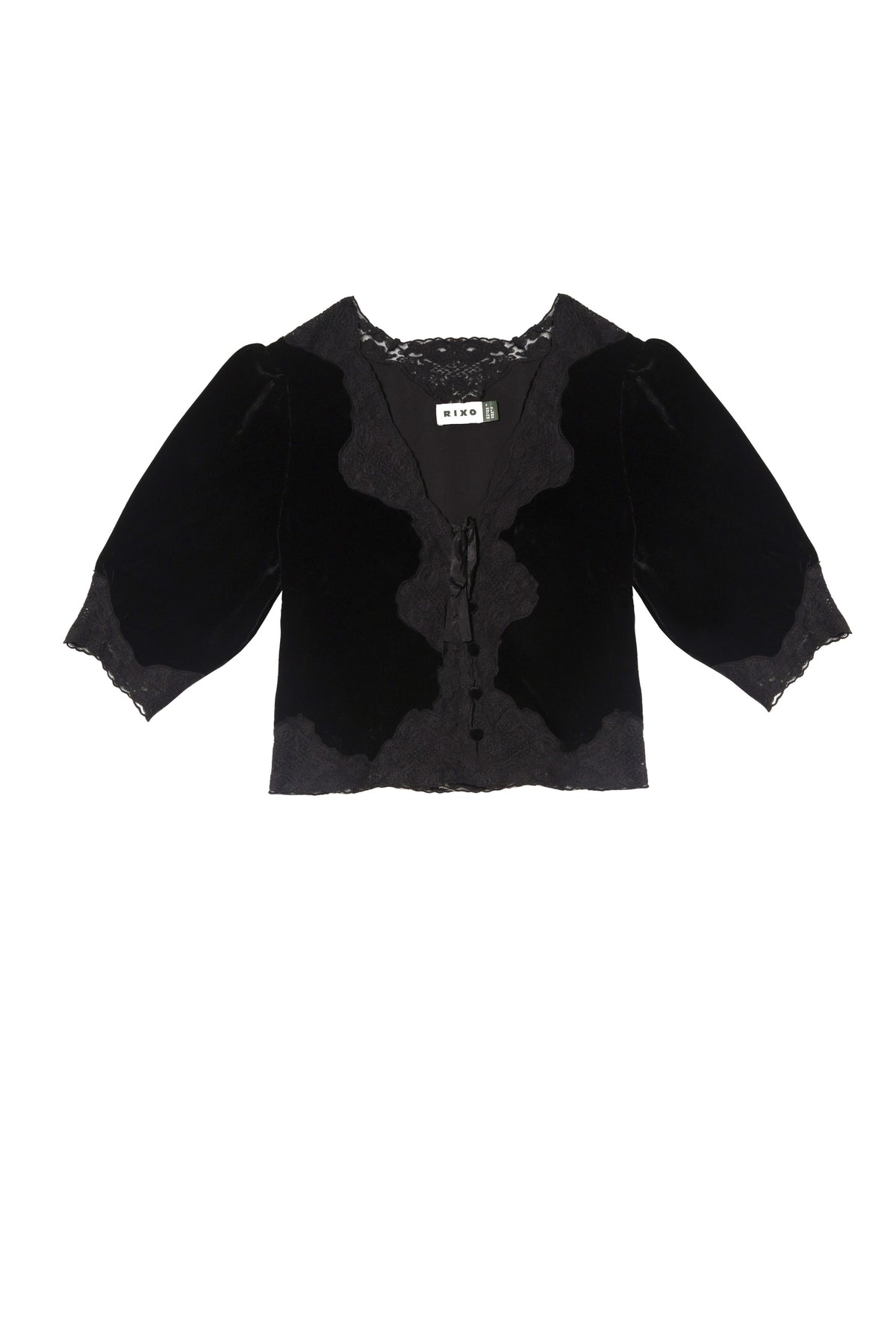 The Ursula - Black blouse features black velvet, three-quarter puff sleeves, lace trim on the neckline and cuffs, and a front tie closure. This elegant MIXO piece exudes vintage charm with its delicate details.