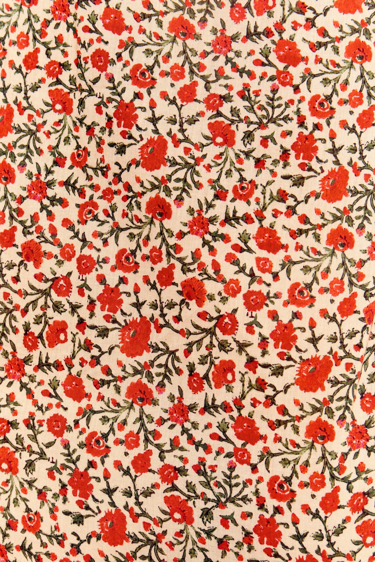 Aprilia - Ditsy Trail Cream features a dense pattern of small red and orange florals with green leaves on light beige cotton-voile, creating a vibrant look ideal for an Aprilia nightdress.