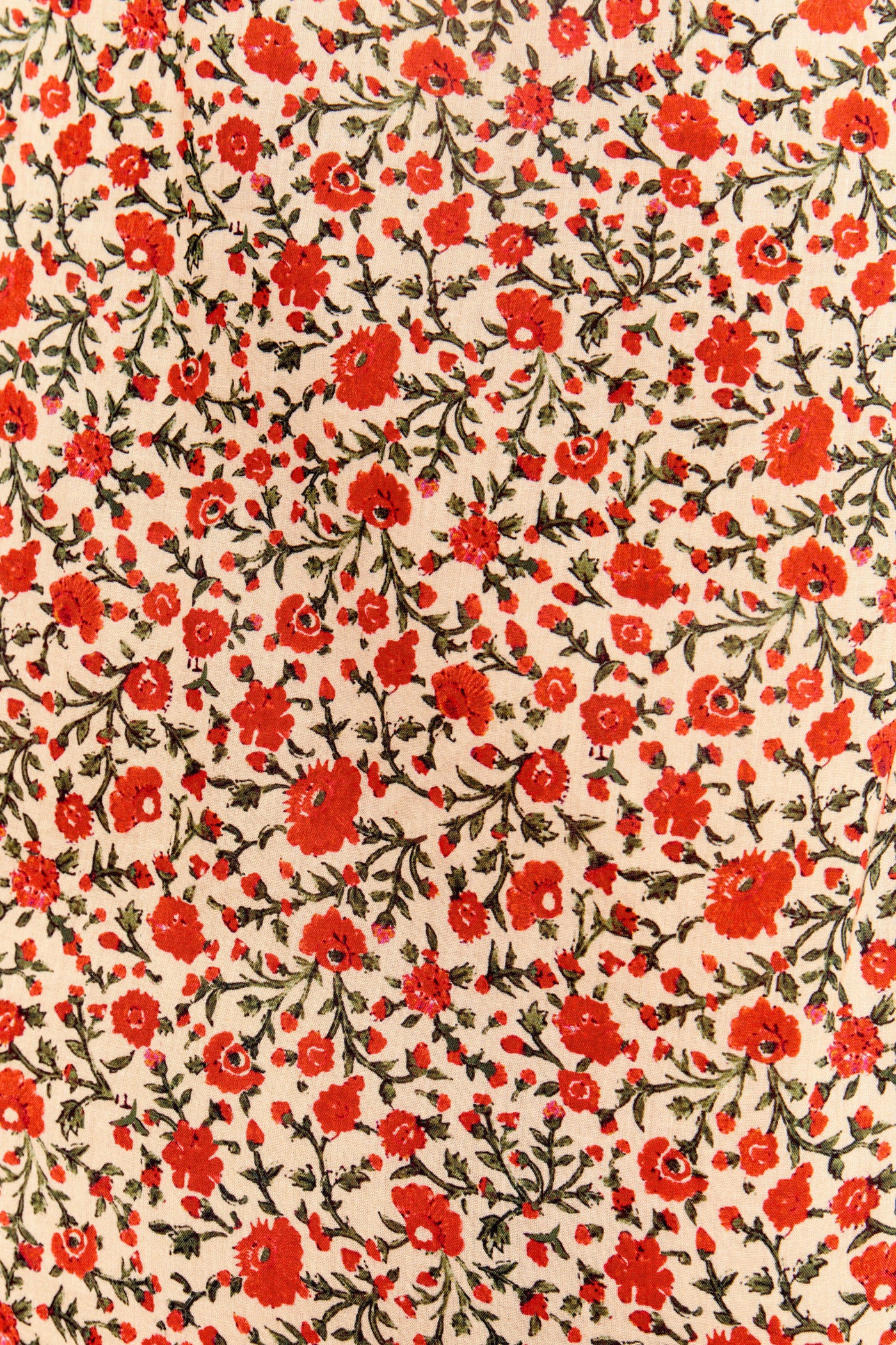 Aprilia - Ditsy Trail Cream features a dense pattern of small red and orange florals with green leaves on light beige cotton-voile, creating a vibrant look ideal for an Aprilia nightdress.