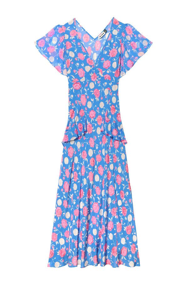 The Evie - Rose Shell Blue is a petite blue silk crepe de chine dress with a v-neckline, short flutter sleeves, pink and white rose print with green leaves, fitted waist with ties, and a slightly flared knee-length skirt.