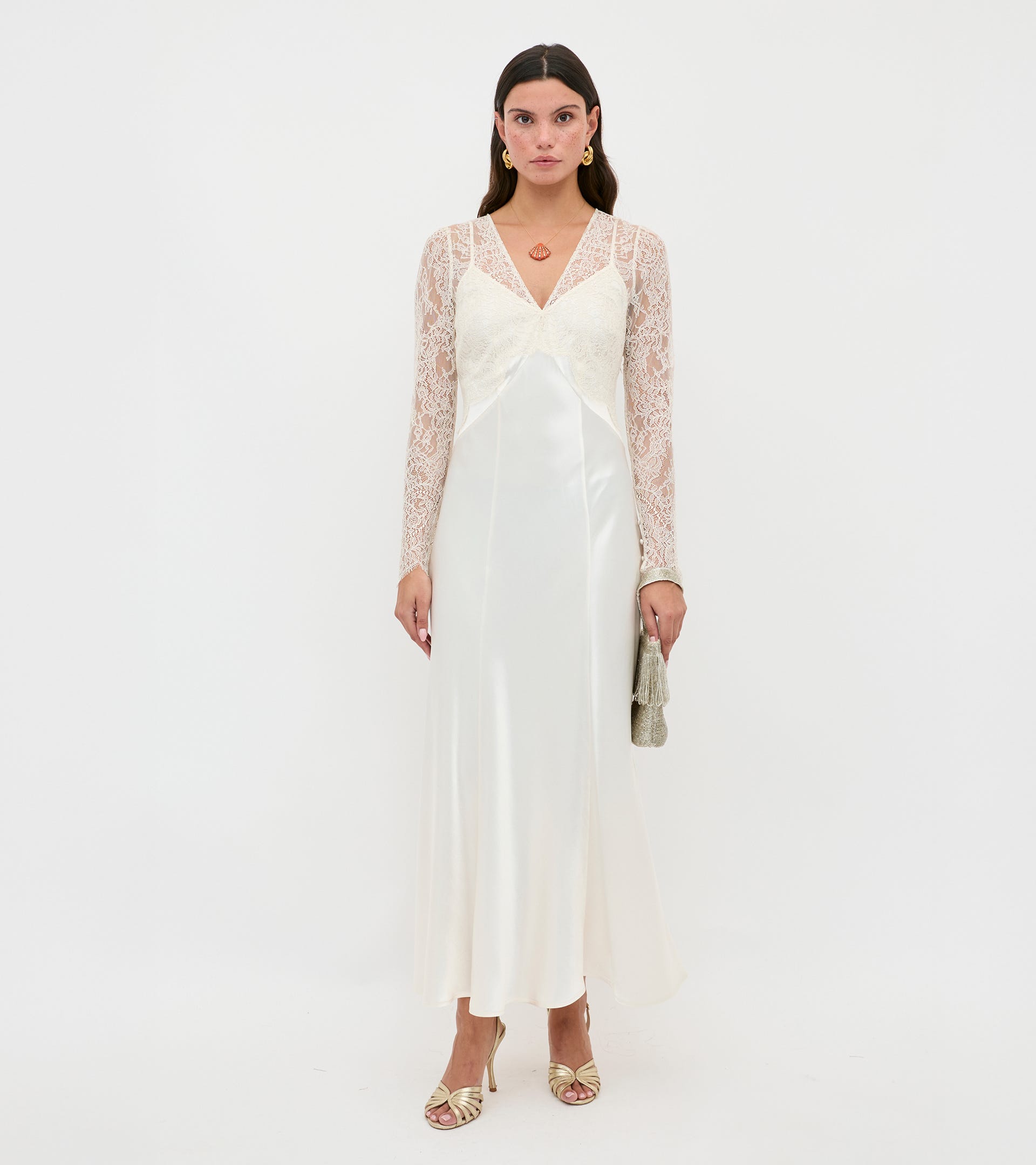 Woman wearing a white dress with lace sleeves on a white background