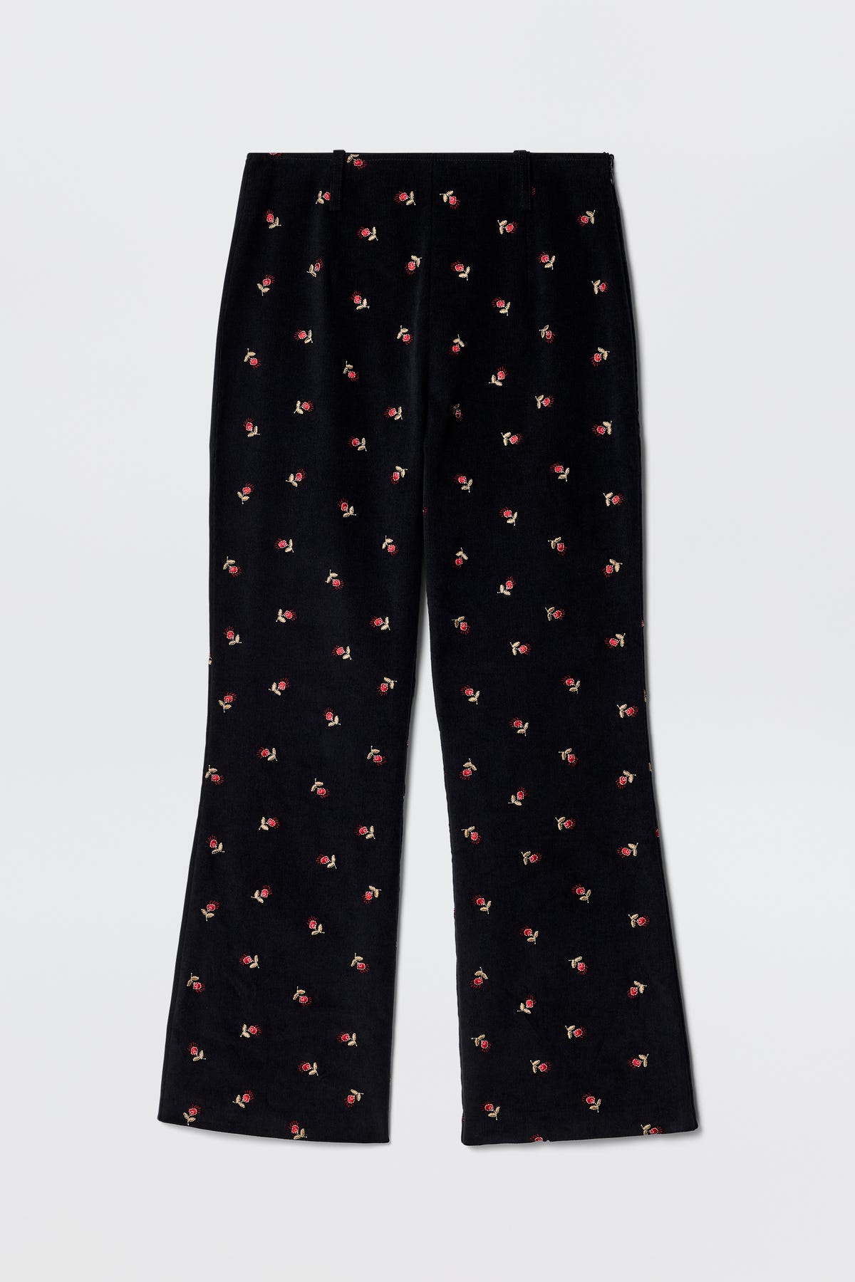 Olwen - Dandy Embroidery Deep Navy fit and flare trousers in black velvet, straight leg, with small red and green embroidered flowers. Vintage-inspired tailoring style shown laid flat on a light gray background.