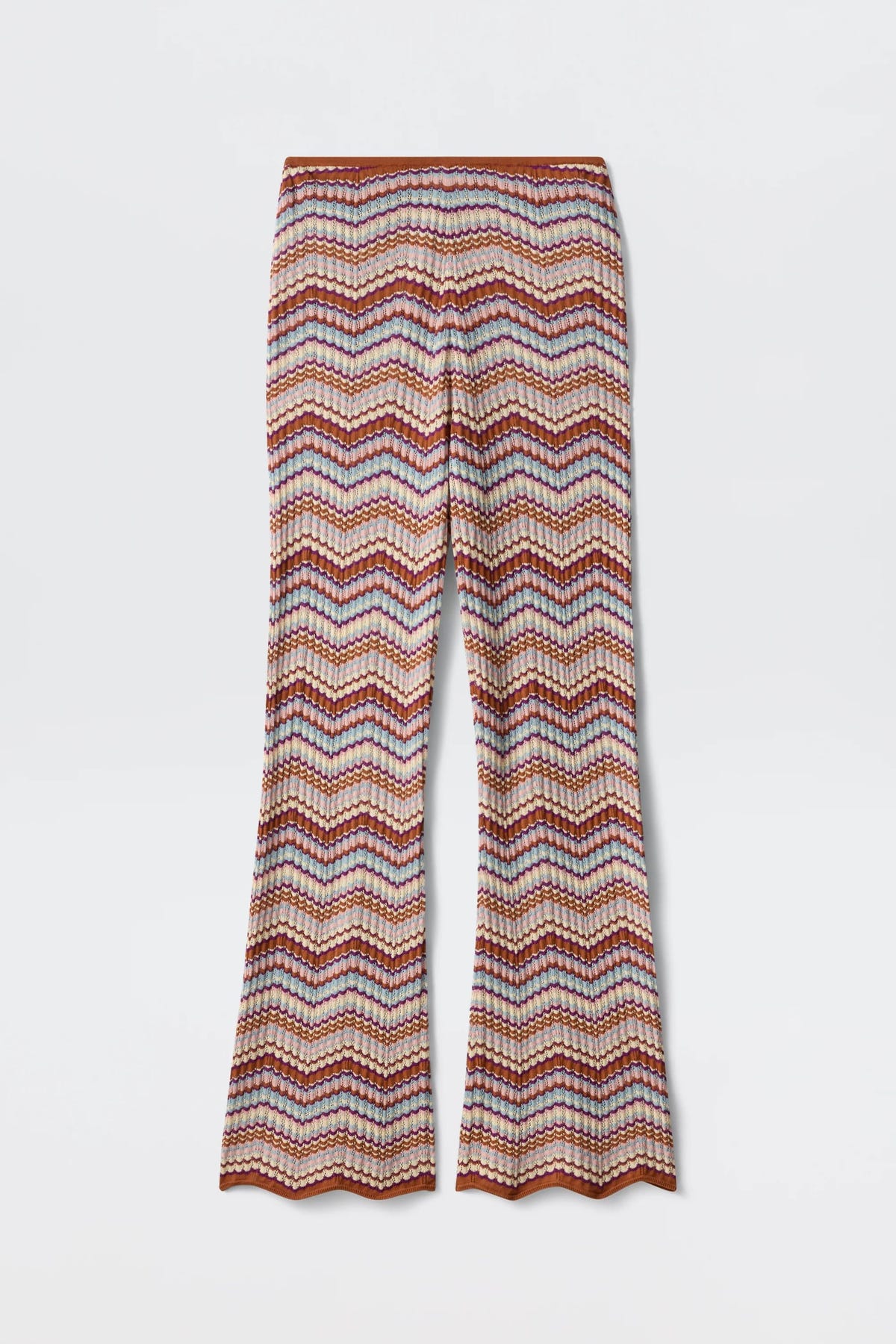 Boni - Maria Chevron Multi pants showcase a vibrant chevron zigzag pattern in orange, pink, and white hues. Crafted from breathable cotton knit, these flared-leg trousers feature a scalloped hem at the bottom, making them a versatile wardrobe essential.