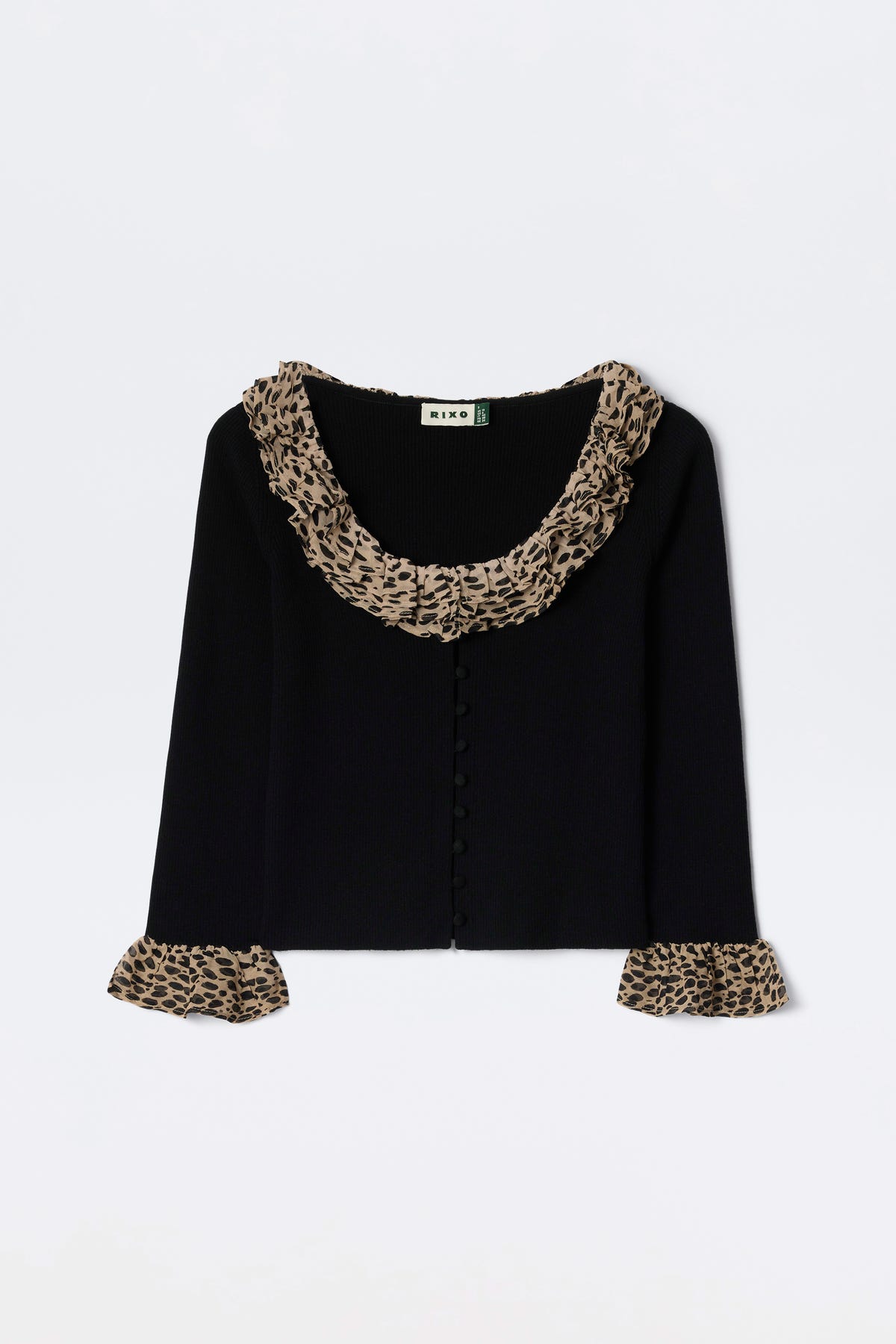 The Laurel - Antelope Spot Black is a black merino wool cardigan with wide ruffled leopard-print trims at the collar and matching cuffs, shown against a white background.