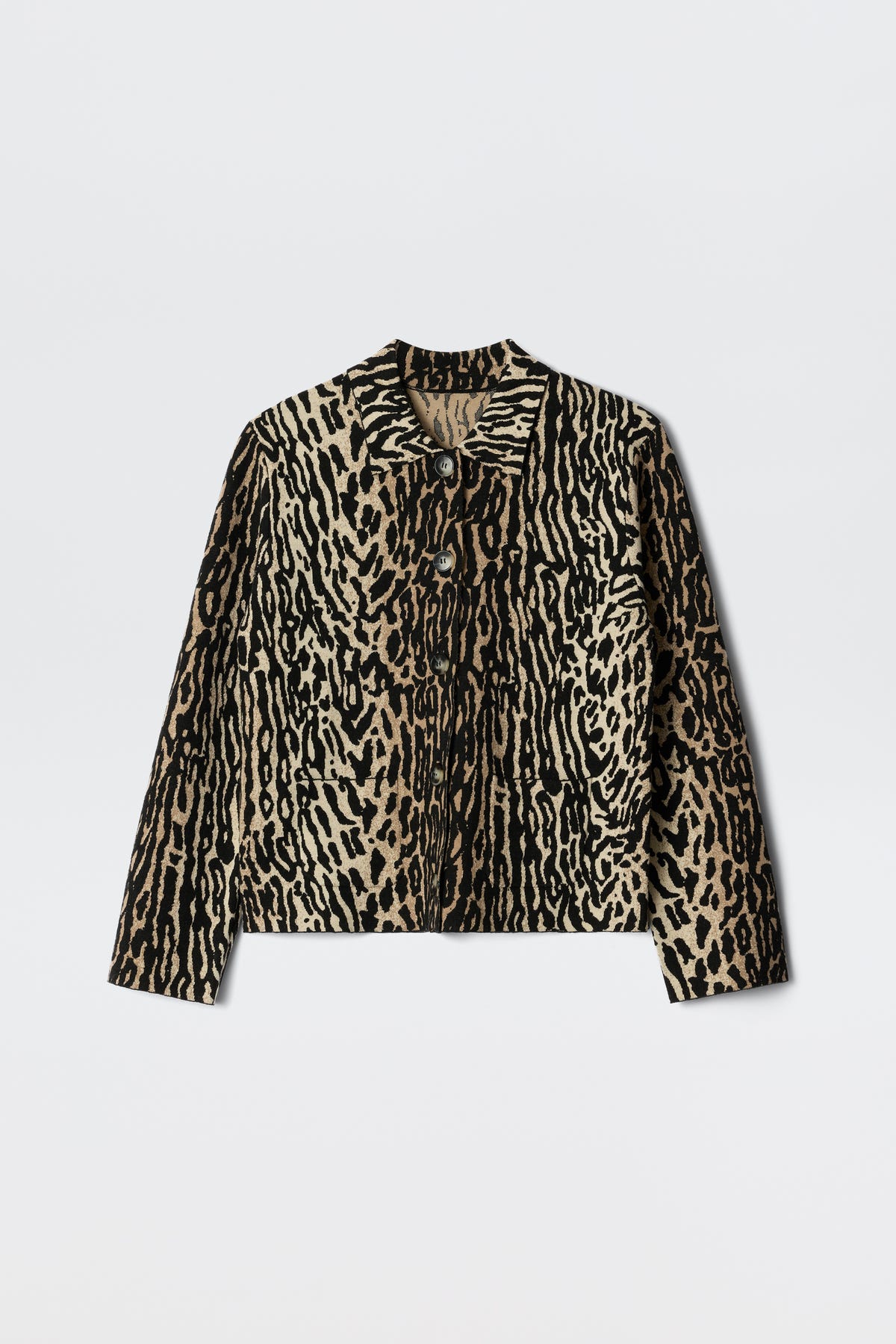 The Trista - Bohemia Leopard Brown is a long-sleeve jacket featuring a tan and black animal print, button-up front, collar, and two chest pockets, shown against a white background.