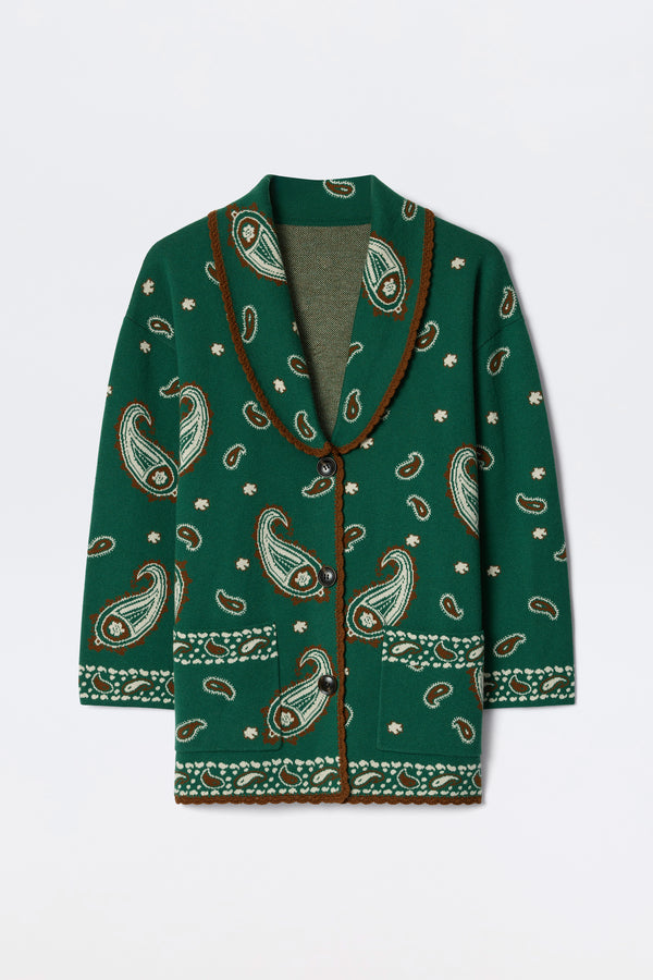 The Morla - Daisy Paisley Green is a green cardigan with brown and white paisley patterns, shawl collar, button-down front, and decorative trim on the edges, cuffs, and hem.