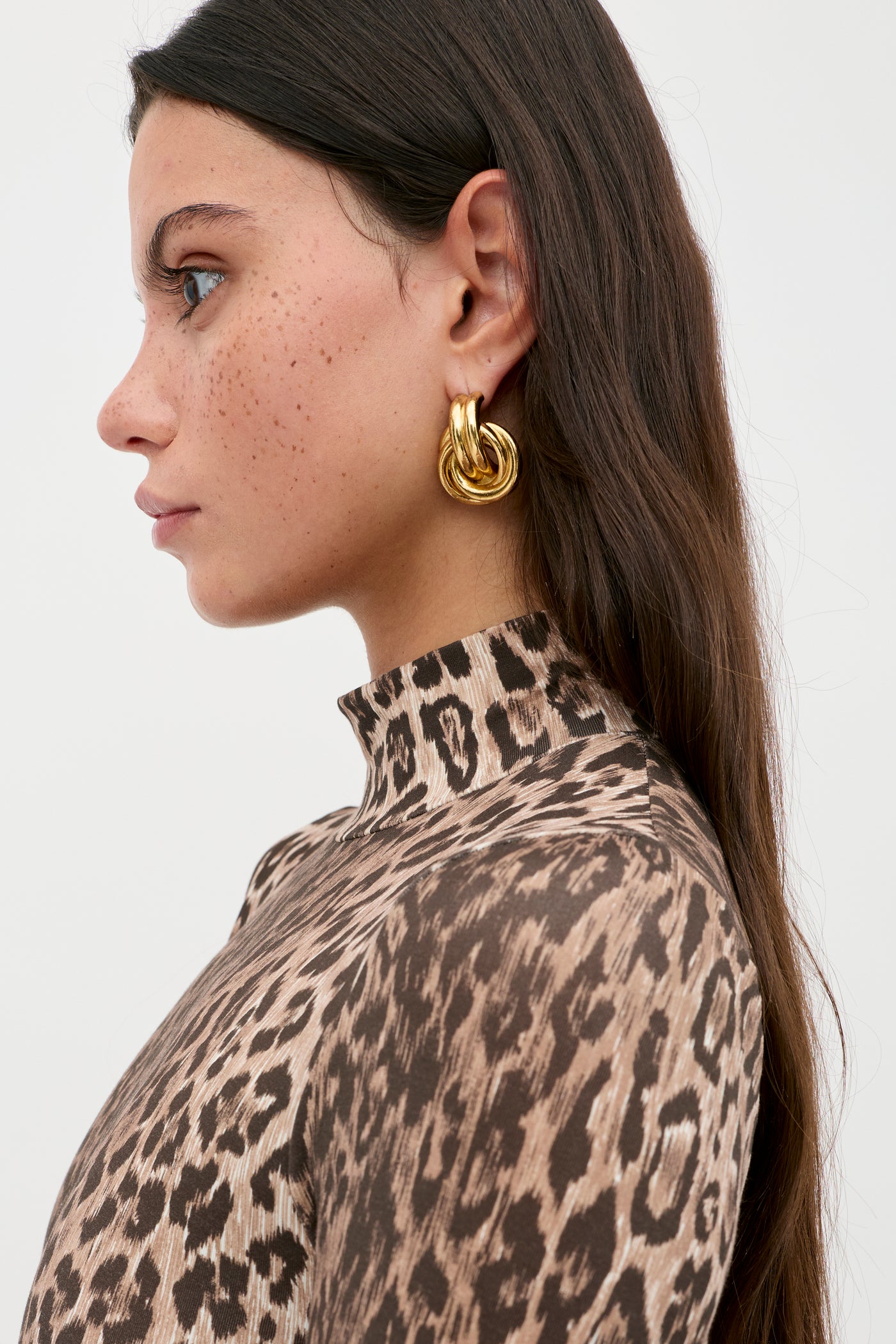 A woman with long hair wearing the Polo - Leopard Brown bodysuit.