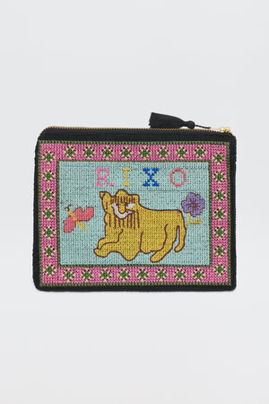 The Beau - Mini Leo Cross Stitch Embroidery Charcoal is a rectangular zip pouch with beaded yellow lion, flowers, “RIXO” on light blue, pink and green floral border, and a zipper finished with a black tassel.