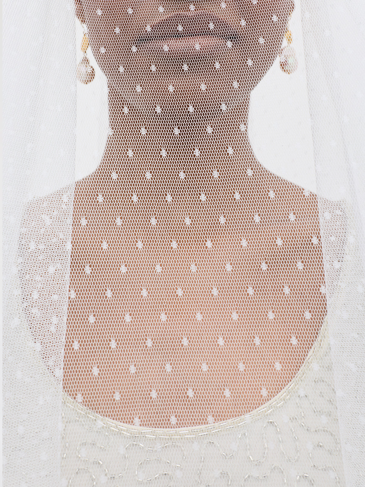 White polka dot mesh apron on a mannequin against a white background