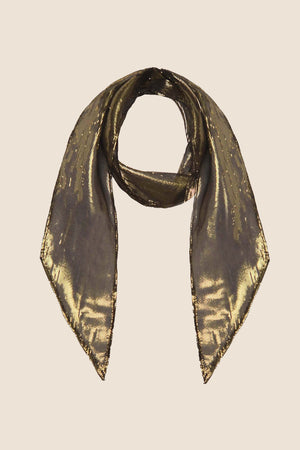 The Alexa - Gold scarf, featuring a sheer fabric with a subtle metallic sheen, is laid flat with pointed ends down and the center looped in a circle on a plain light background.