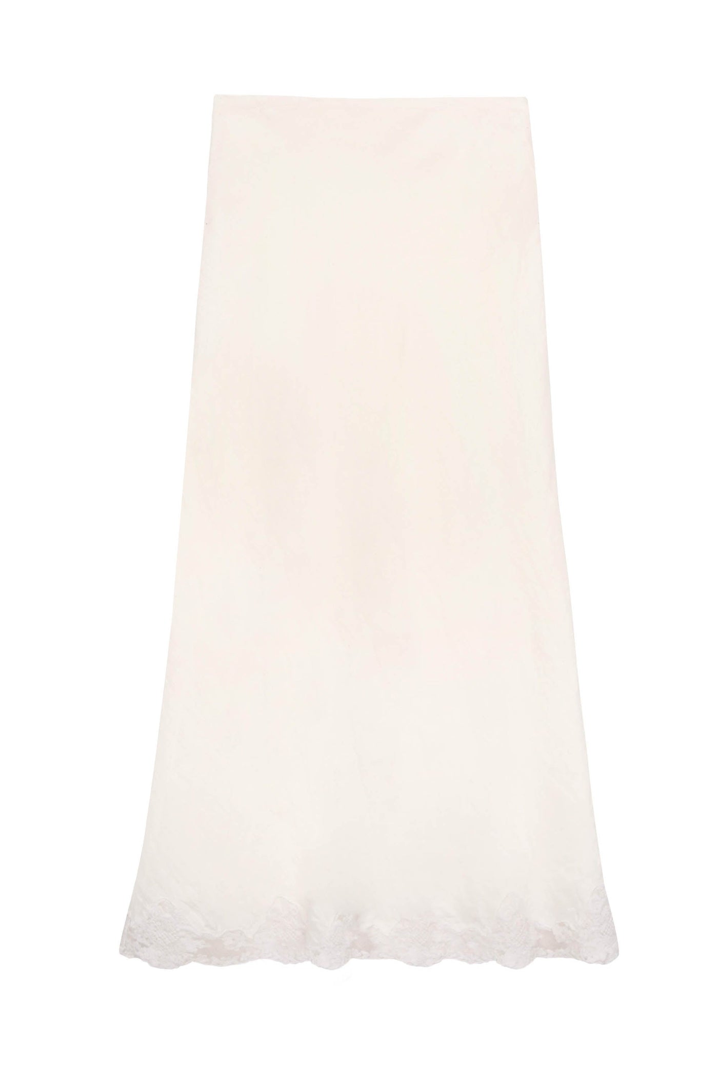The Crystal - Cream is a long, cream midi slip skirt with a subtle floral pattern and delicate lace trim along the scalloped hem, shown against a plain white background.