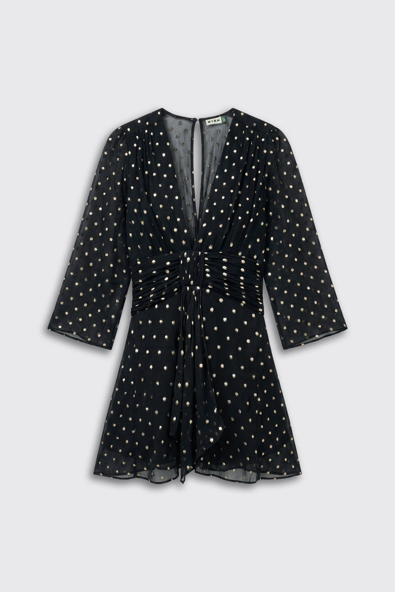 Clove - Gold Spot Black mini dress with three-quarter sleeves, a deep V-neck, and a gathered waist, featuring an all-over gold polka dot pattern.