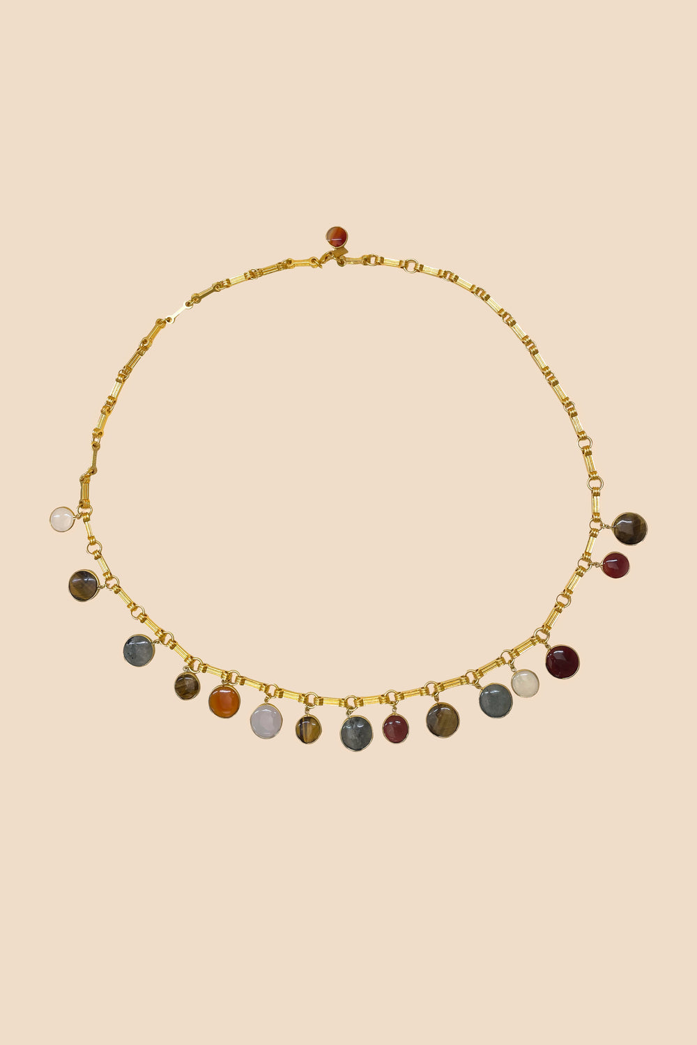 Rixo Isolde is a chain belt adorned with 18-carat gold plating in an antique shade inspired by vintage. Each coin charm is beset with a real labradorite, agate, or tiger-eye stone that flatters any outfit but best complements your favourite RIXO pieces. 