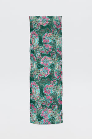 A rectangular piece of fabric, Julien - Butterfly Bloom Green, featuring a vibrant butterfly bloom pattern in green, pink, and teal stands upright against a plain white background.