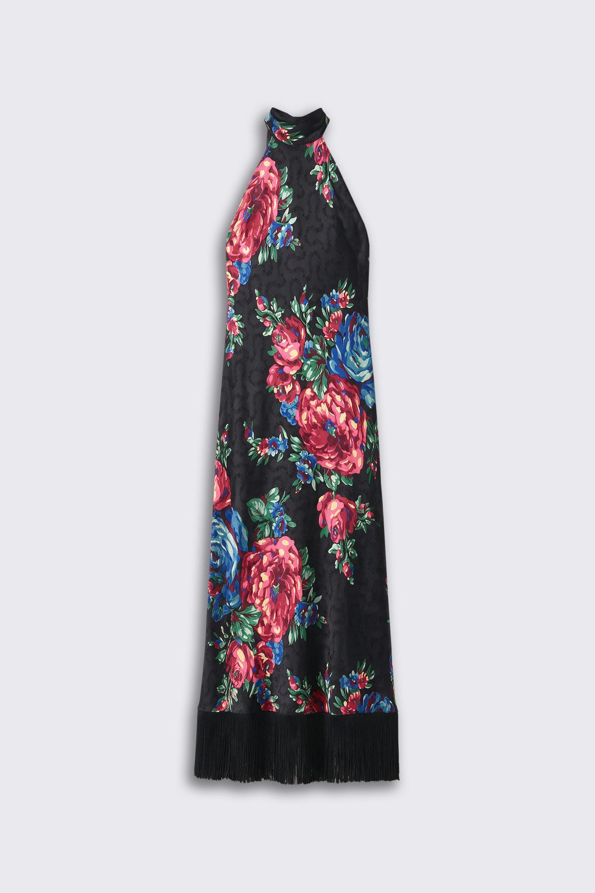The “Maura - Vintage Bouquet Black” dress features a black halter-neck design adorned with a bold floral pattern in shades of red, pink, blue, and green, finished with a black fringe trim along the bottom hem. The dress is displayed against a plain light background.