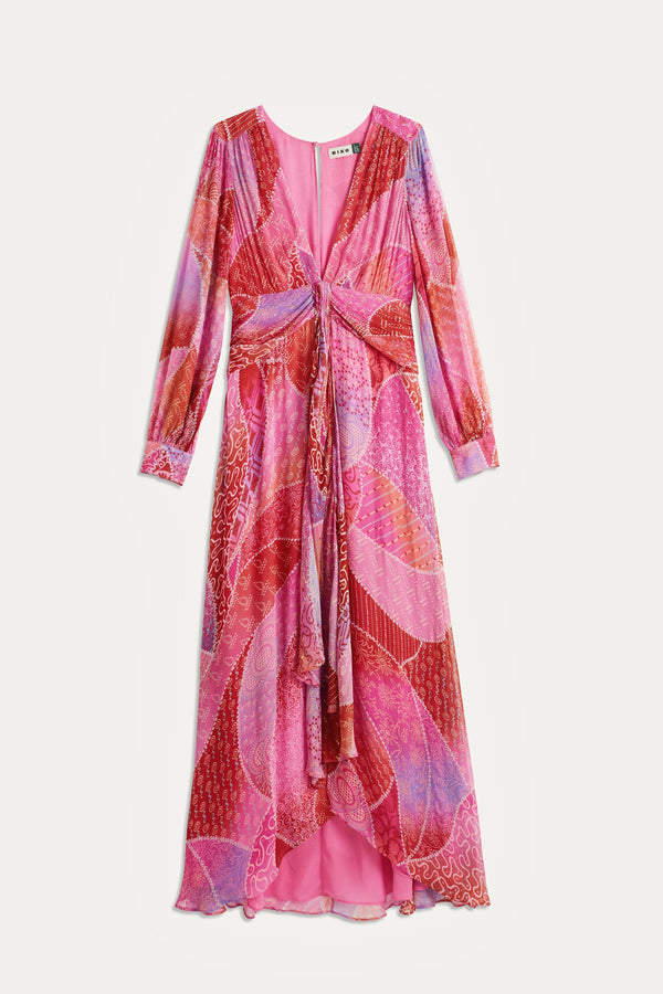 The Meera - Ibiza Night Sunset is a long-sleeved, V-neck maxi gown with a knotted front and flowing hem, featuring a vibrant pink, red, and purple abstract print on lightweight crinkled-chiffon.