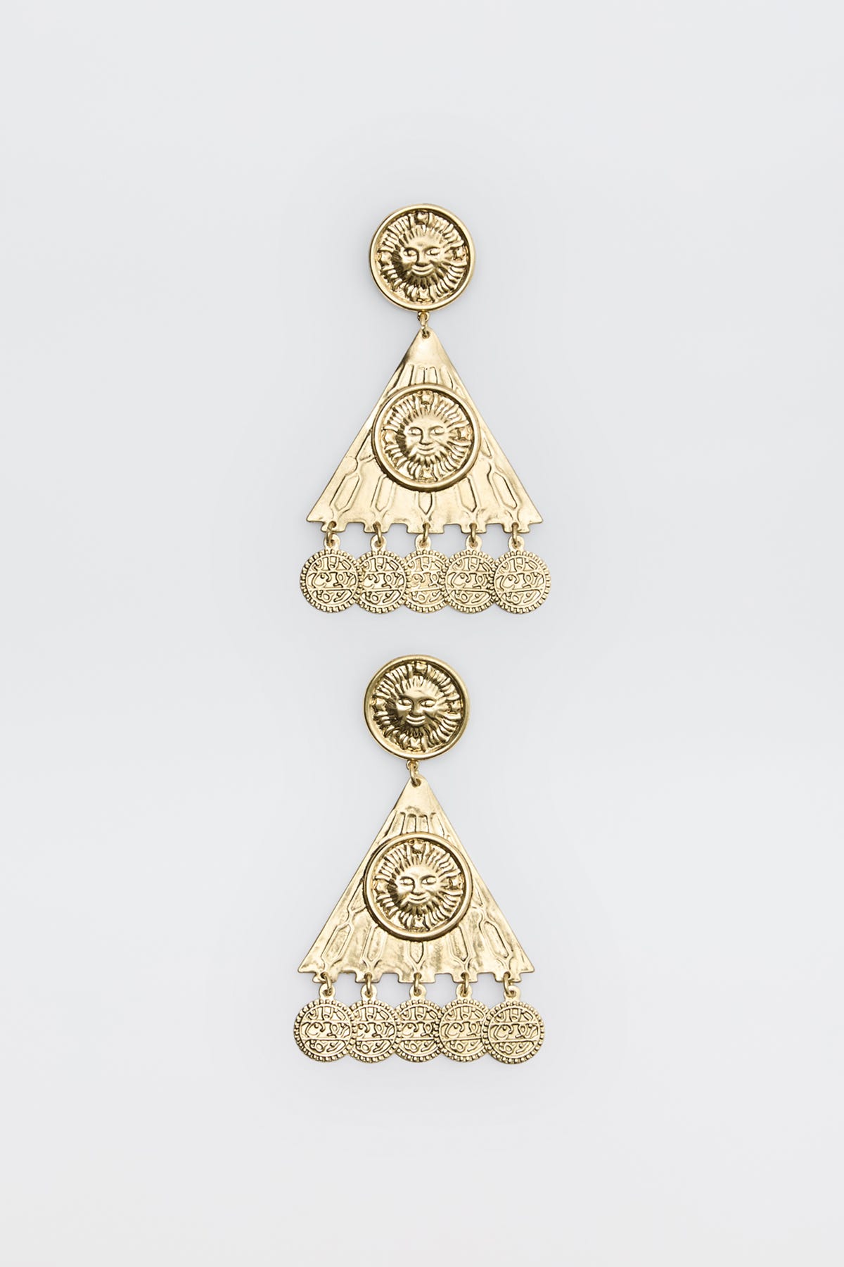 Two ornate gold earrings from the Miray - Gold collection, featuring circular sun motifs at the top, triangular sections, and dangling round charms. The intricate design is enhanced by engraved patterns and a lustrous, shiny finish, showcased against a plain white background.