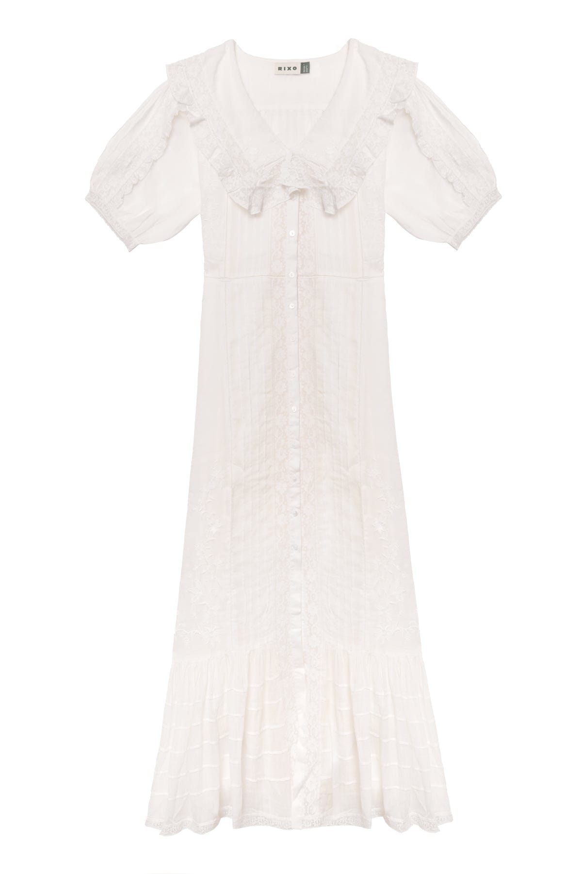 The Edina - Pansy Embroidery White dress features short sleeves, a ruffled collar, button-down front, midi length, delicate lace embroidery, flared hem, and an adjustable waist for a vintage-inspired look.