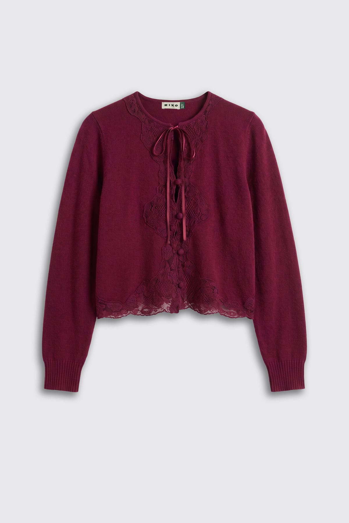 Tassia – Burgundy: A long-sleeve, burgundy knit cardigan featuring lace trim, a scalloped hem, and a front lace-up tie closure.