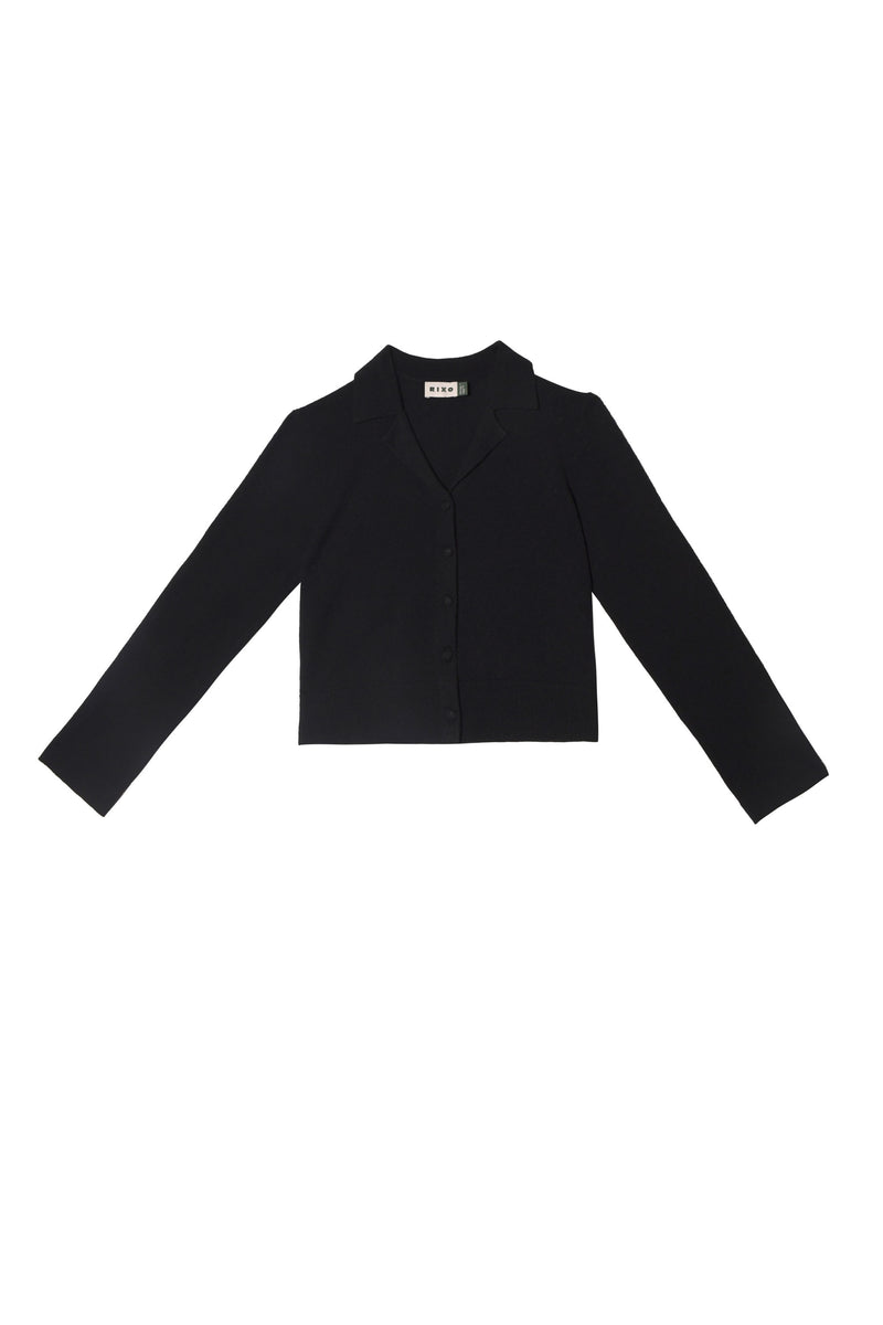 The Carla - Black is a long-sleeved, black cropped blazer made from a luxurious wool-cashmere blend, featuring a collar and front buttons, shown against a plain white background.